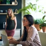 Smiling Asian businesswoman working at a table in an office