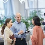 Smiling Manager Talking to Trainees in Office