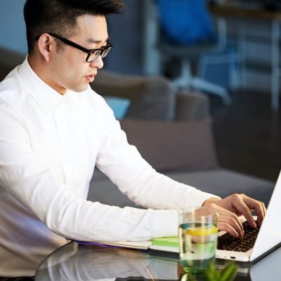 Young asian businessman working with laptop at office